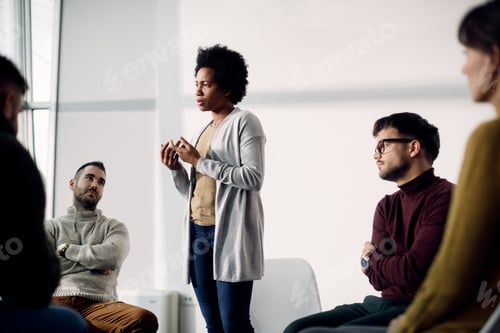 Preview: African American woman talking about her issues during group therapy.