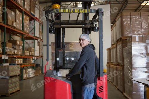 Preview: Factory worker with fork lift in warehouse