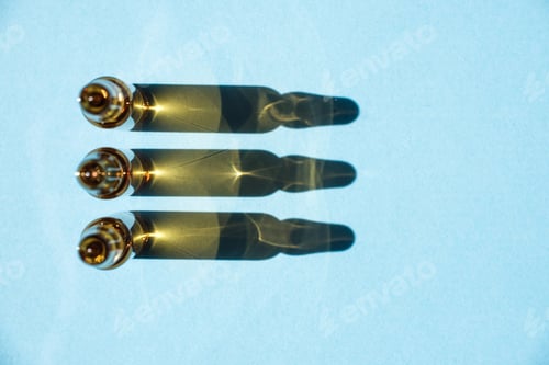 Preview: Cosmetic or medical ampoules on a blue background in a row.