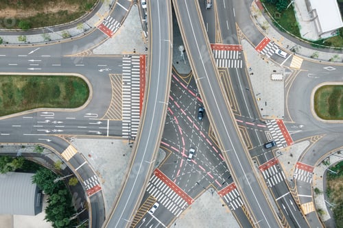 Preview: Cars driving on a city road junction aerial view.