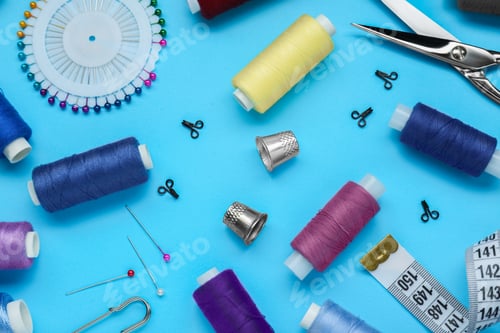 Preview: Flat lay composition with thimbles and different sewing tools on light blue background