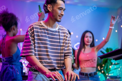 Preview: Asian young man artist DJ mixing and scratching music mixer controller.