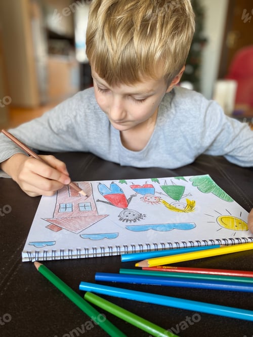 Preview: boy draws his family with colored pencils