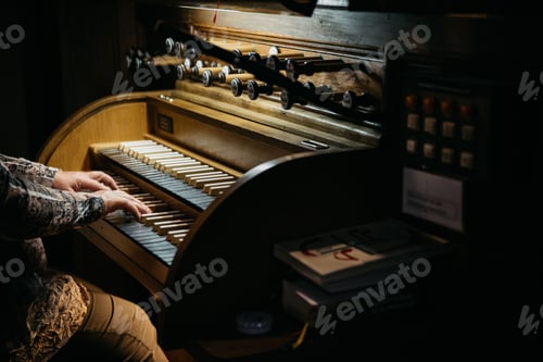 Preview: Closeup of a person playing the piano in dim lighting