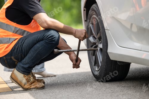 Preview: Mechanic team working road assistant help to replace flat tire service at roadside with safety