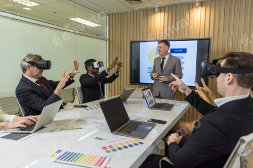 Preview: business persons with virtual reality headsets in meeting room at the office.