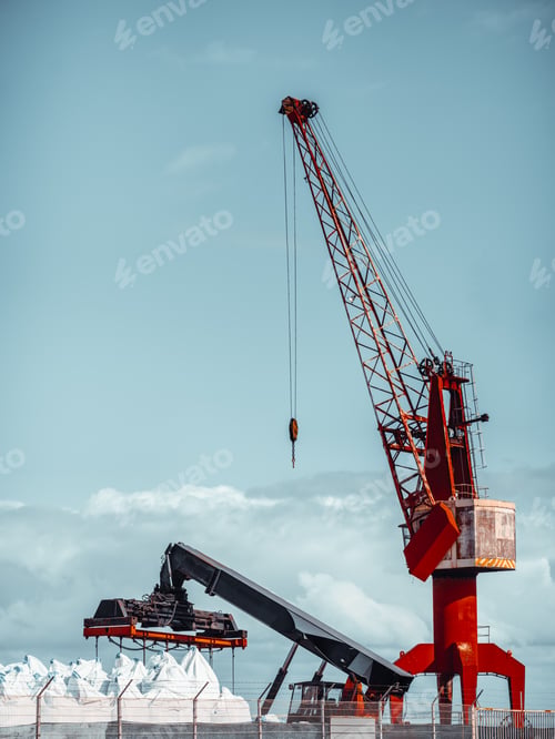 Preview: Red crane lifting cargo at harbor