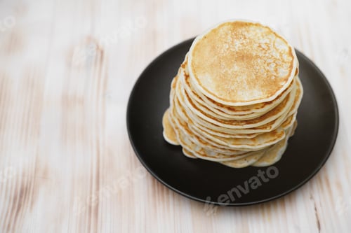 Preview: stack of classic american pancakes on a wooden table