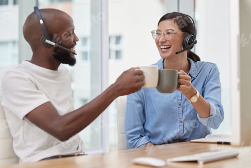 Preview: Cheers to a beautiful day. Shot of two colleagues enjoying their coffee together.