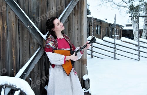 Preview: Russian woman with balalaika on wooden vallage background