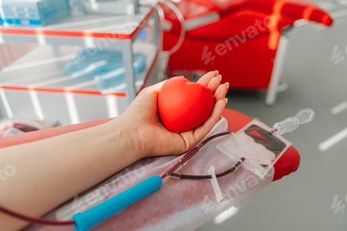 Preview: Young woman making blood donation in hospital. Blood donation.