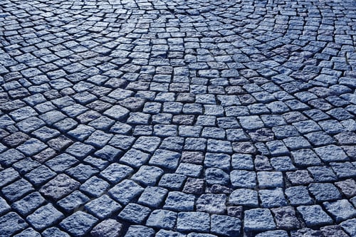 Preview: Street paving stone in blue tone. Antique urban sidewalk. Horizontal