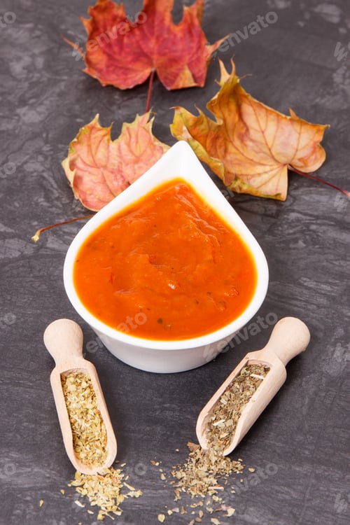 Preview: Pumpkin ketchup or sauce with spices and autumnal leaves