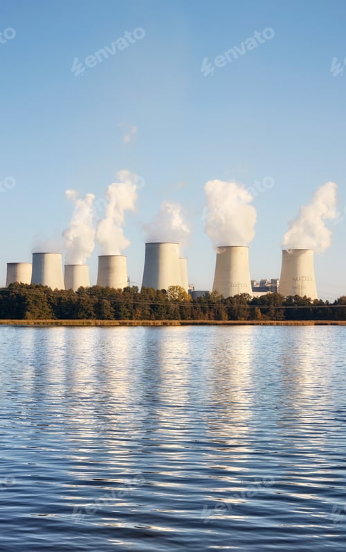 Preview: Smoking chimneys by a lake.