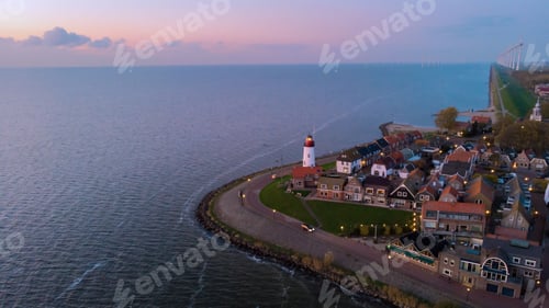 Preview: Urk Flevoland Netherlands sunset at the lighthouse and harbor of Urk Holland. Fishing village Urk