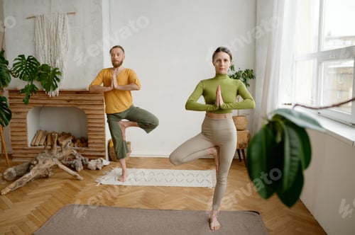 Preview: Adults Practicing Yoga in Living Room at Home