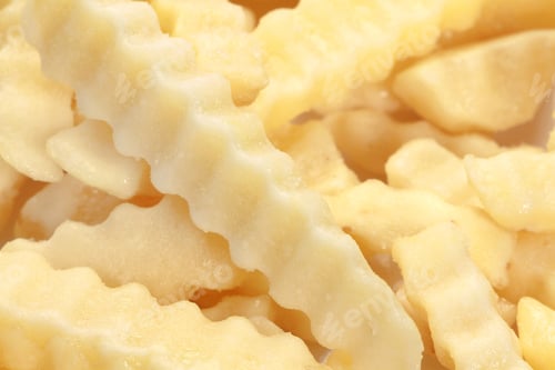 Preview: Closeup shot of a crinkle fries isolated on a white background