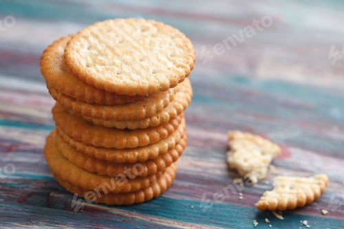 Preview: Stack of a of salted crackers on an old wooden table.