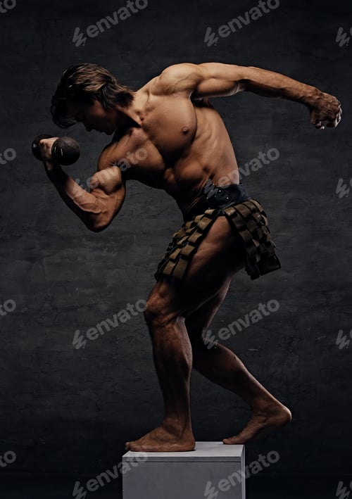 Preview: Muscular male posing on podium and holds dumbbell.