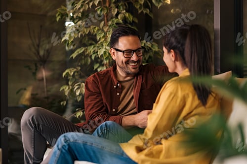 Preview: Businessman and businesswoman enjoying their break from work, talking to each other, sitting.