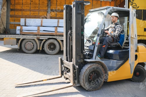 Preview: Portrait of professional forklift driver in factory's warehouse