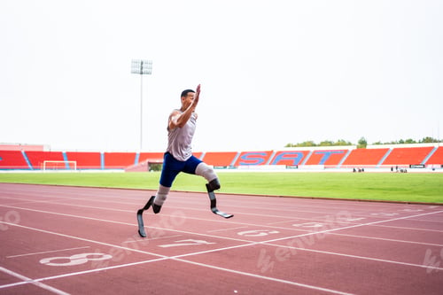 Preview: Asian para-athletes disabled with prosthetic blades running at stadium.