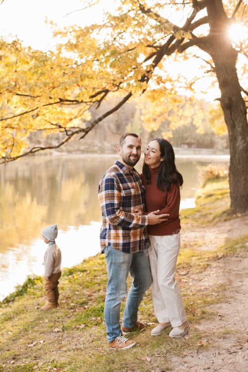 Preview: Happy family standing by the lake in autumn park, loving relationship and family time in october