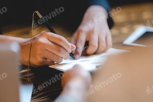 Preview: Working on Business Report with Graph and Pen