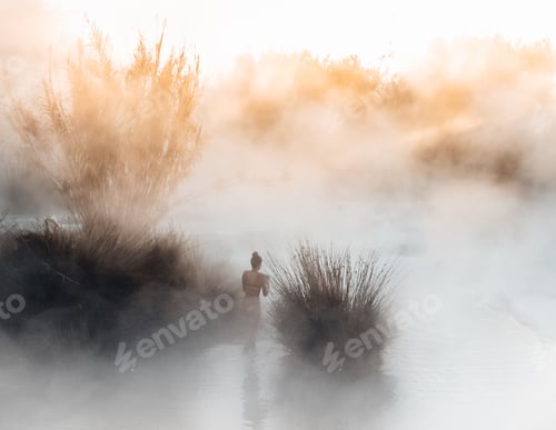 Preview: person walking through steamy water on a hot day in a desert area