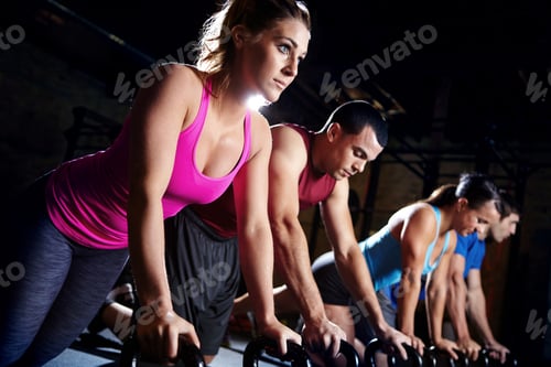 Focused People Doing Kettlebell Exercises in Gym