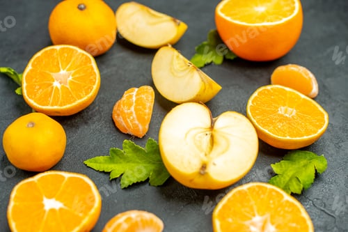 Preview: top view cut oranges and apples on dark background