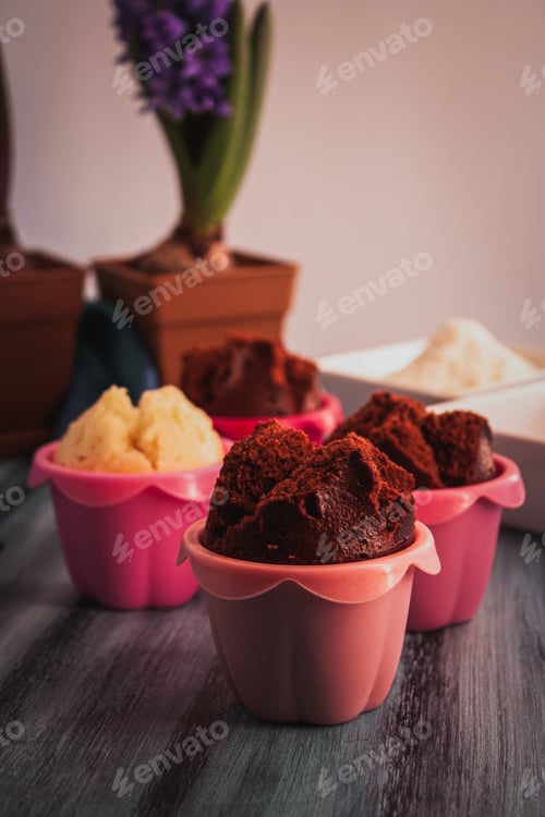 Preview: Homemade Japanese muffins with cocoa and vanilla on colorful wooden surface