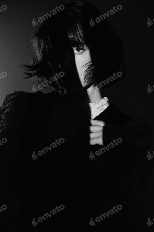 Preview: Studio shot of a young woman in a ray of light.