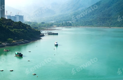 Preview: Landscape view of sea ocean with speed boat and mountain in sunny day.