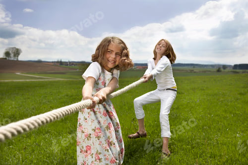 Preview: Children pulling a rope in countryside