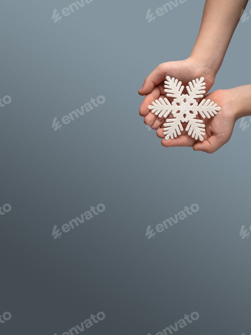 Preview: The snowflake in the hands on blue background