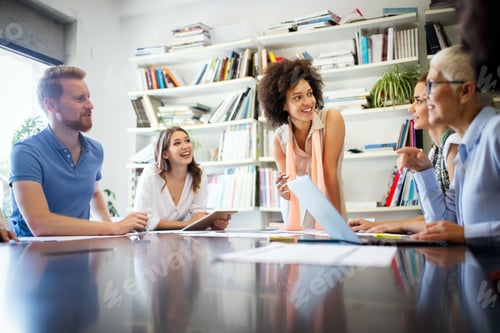 Preview: Group of business people working and communicating in office together with colleagues