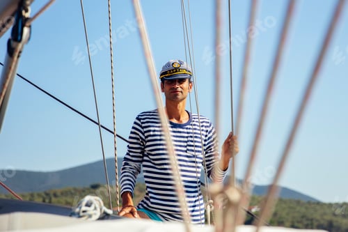 Preview: Handsome young man on a sailboat