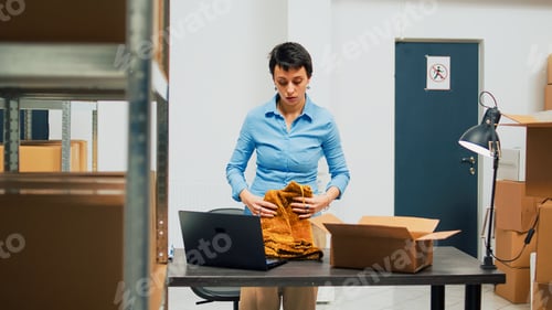 Preview: Young adult using storage room supplies to put in carton packages