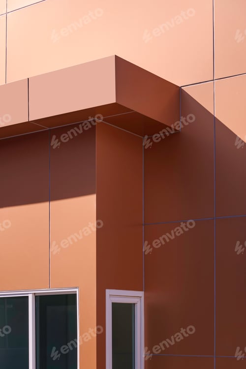 Preview: Sunlight and shadow on surface of brown aluminium composite tile wall of modern sentry box room