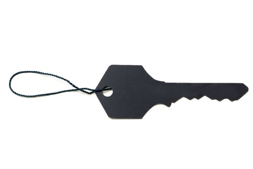 Preview: Unique black key with a textured design and a looped string for easy carrying