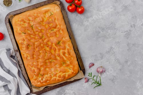 Preview: Traditional Italian Fresh Baked Focaccia with rosemary, garlic, sea salt and olive oil. Top view.