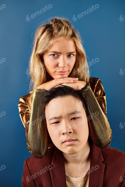 Preview: adorable multicultural stylish teenagers in vibrant clothes posing together and looking at camera