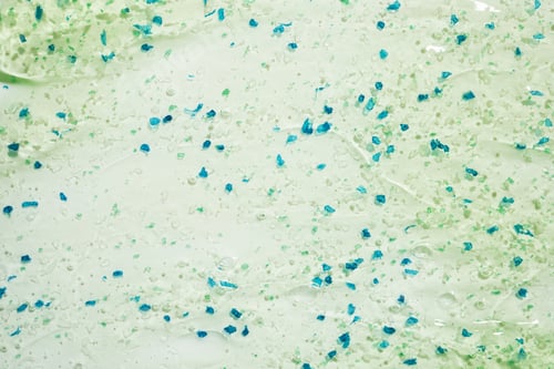 Preview: Abstract green and blue microplastic particles on light background