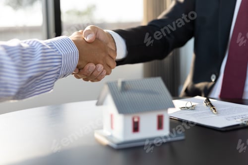 Preview: Real estate agents businessmen shake hands after the signing of the contract agreement is complete.