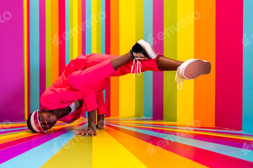 Preview: Beautiful young woman dancing and having fun inside a rainbow box room