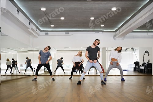Preview: Group of young modern dancers dancing in the studio