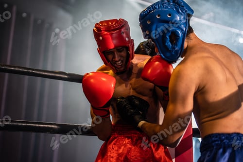 Preview: Two young professional boxer having a competition tournament on stage.