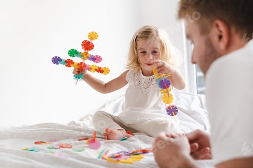 Preview: Happy cute caucasian two years old toddler, girl playing with adult, man .Fathers day
