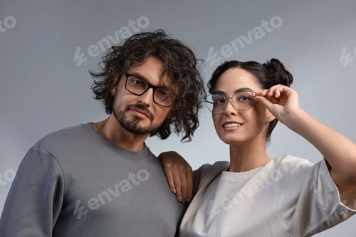 Preview: Eyewear concept. Portrait of gorgeous fashion couple in casuale clothes wearing trendy glasses and